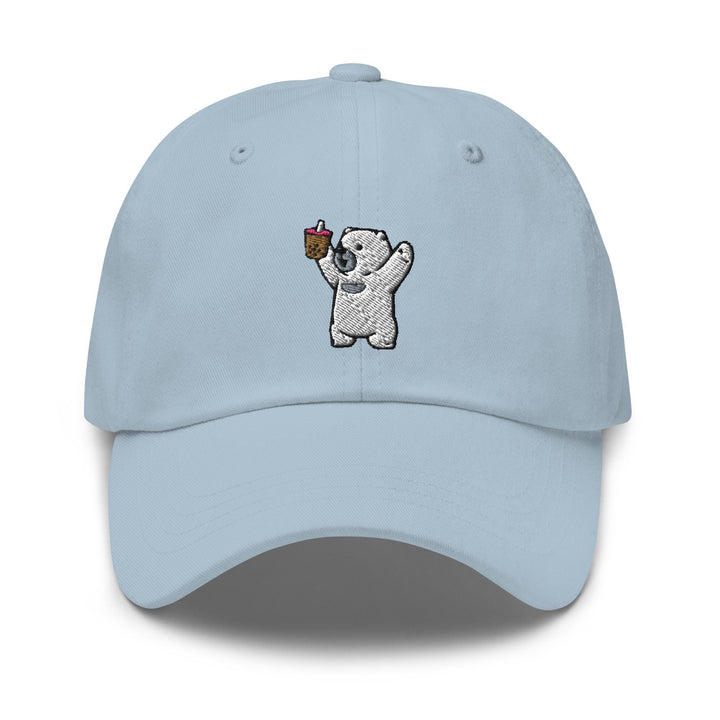 a light blue hat with a koala bear holding an apple