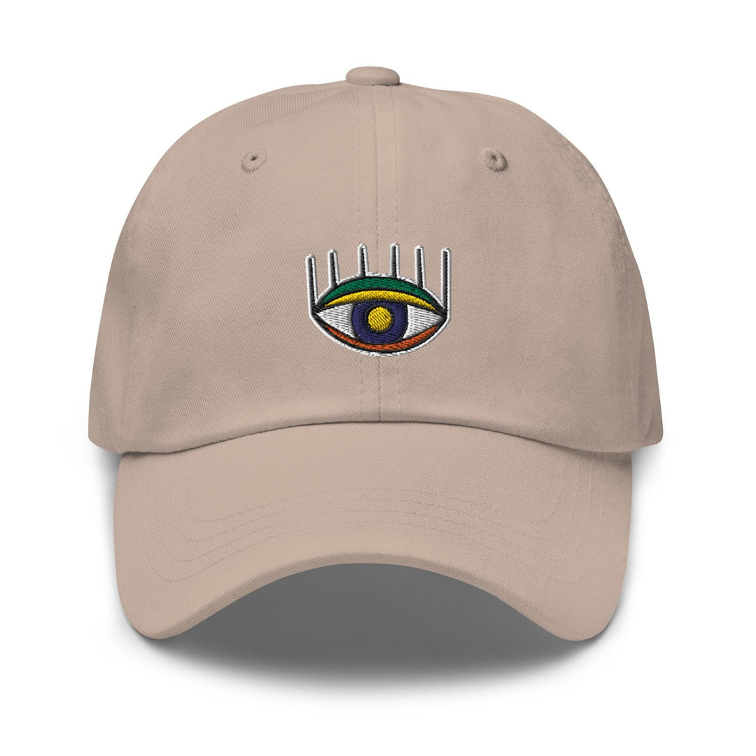 a tan hat with an eye and a comb on it