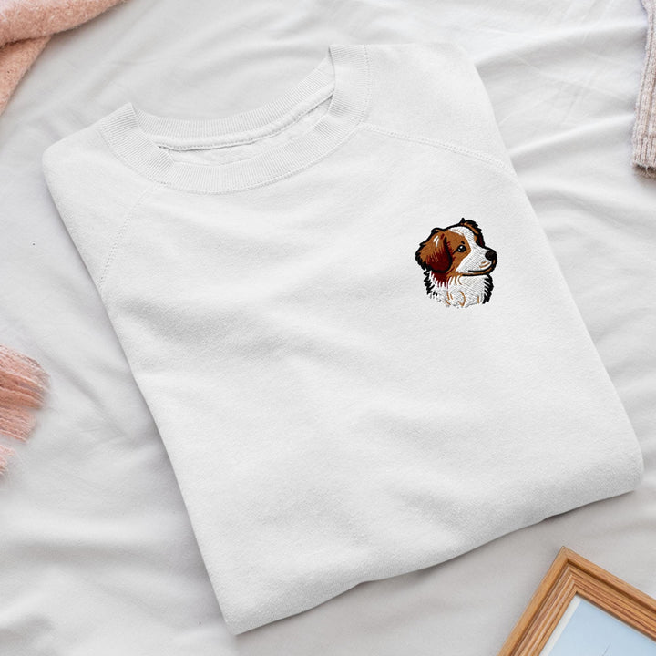 a white shirt with a brown and white dog on it