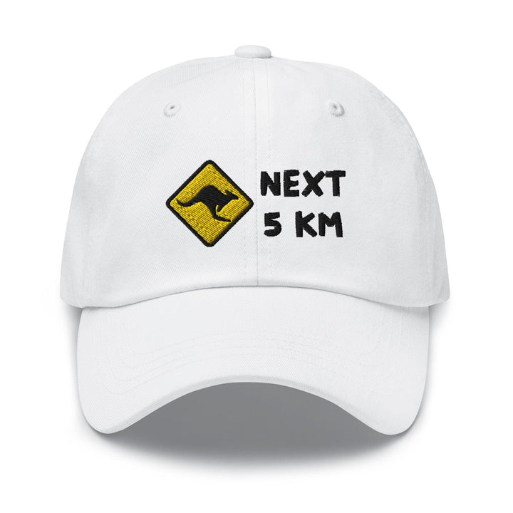 a white hat with the words next 5 km printed on it