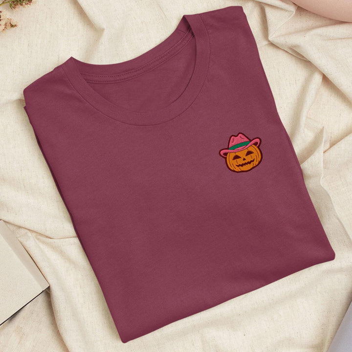 a t - shirt with a picture of a pumpkin wearing a hat