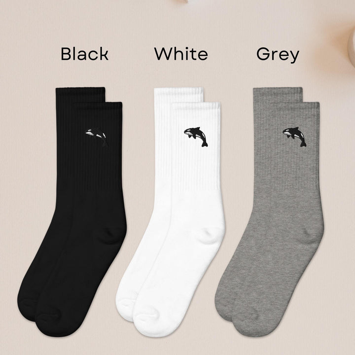 three pairs of black, white, and grey socks