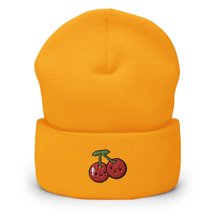 a yellow beanie with cherries on it