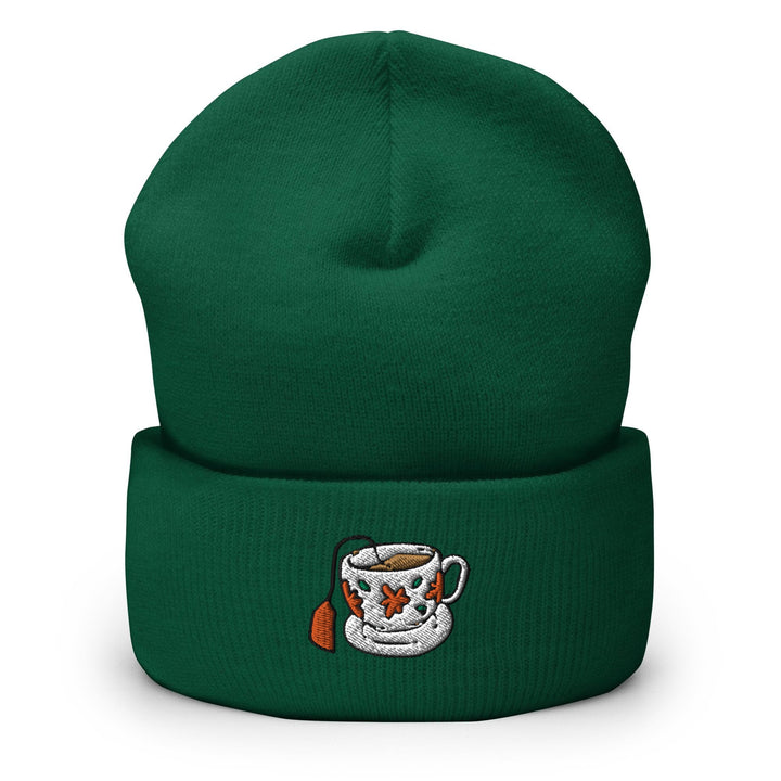 a green beanie with a picture of a coffee cup on it