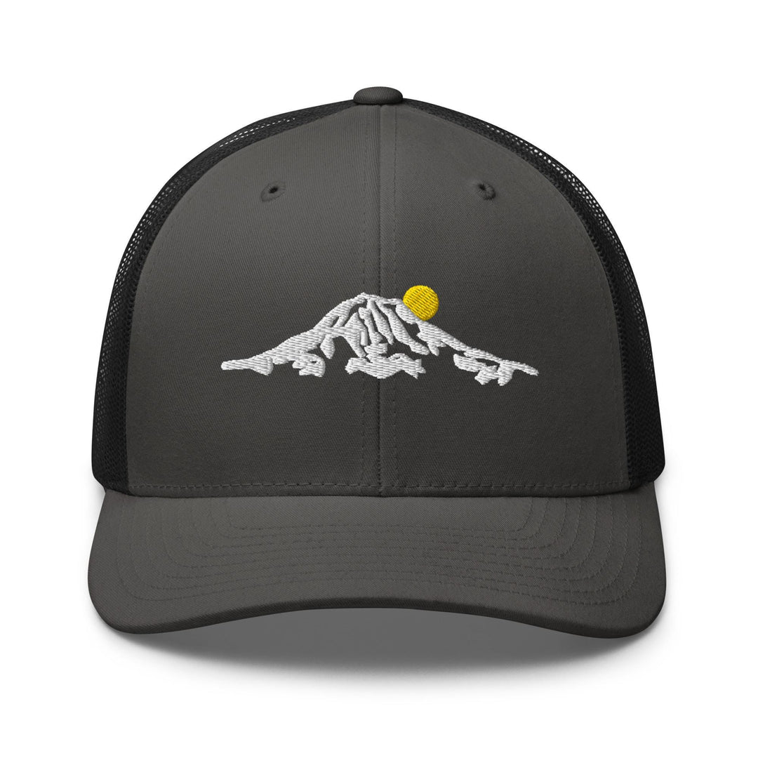 a gray and black trucker hat with a yellow ball on top of a mountain