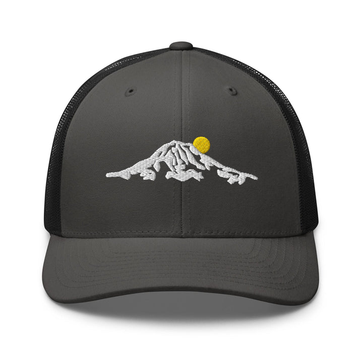 a gray and black trucker hat with a yellow ball on top of a mountain