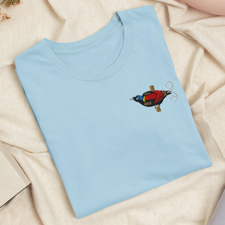 a blue t - shirt with a bird embroidered on it