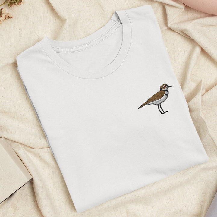 a white t - shirt with a bird embroidered on it