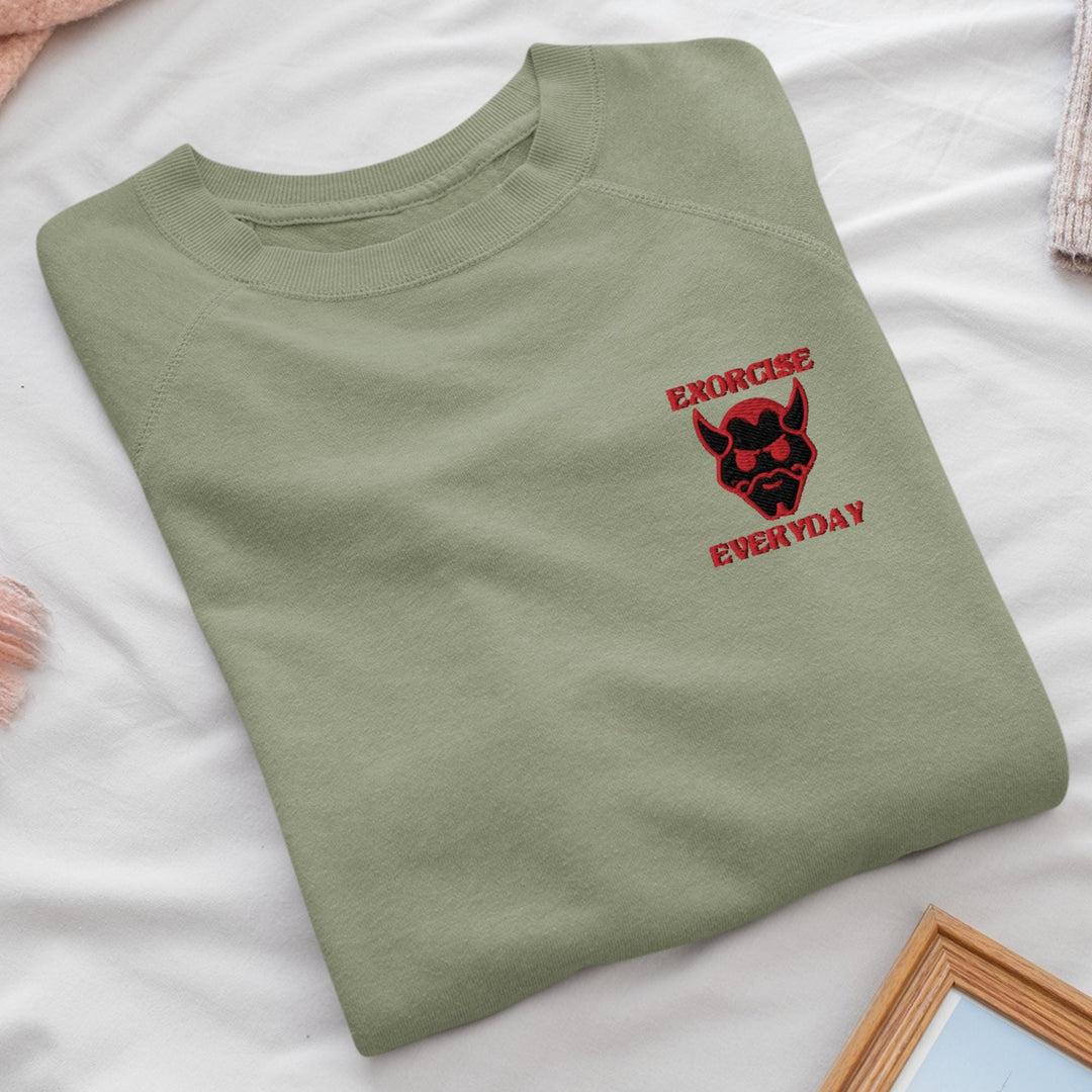 a green t - shirt with a red logo on it