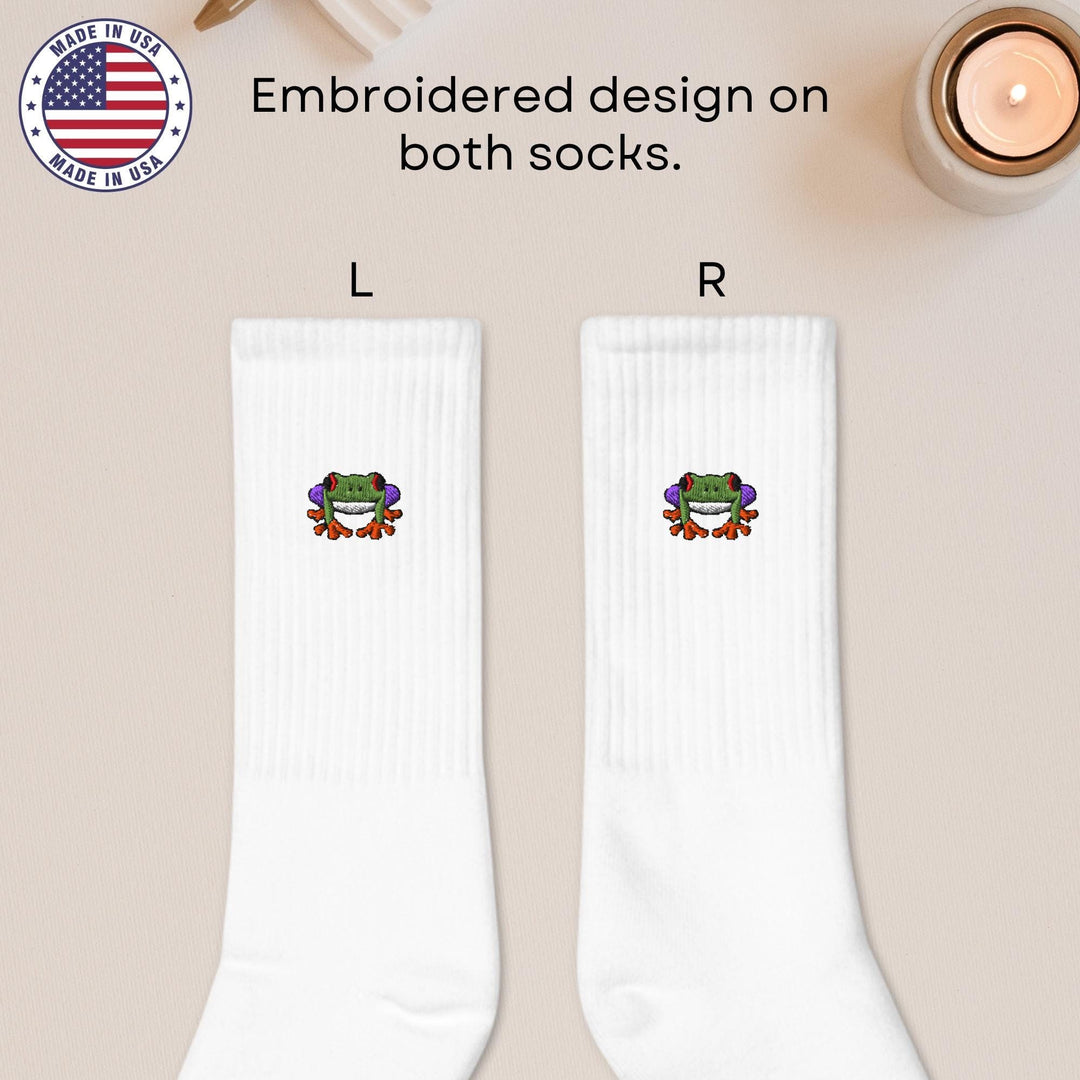 a pair of white socks with a frog on it