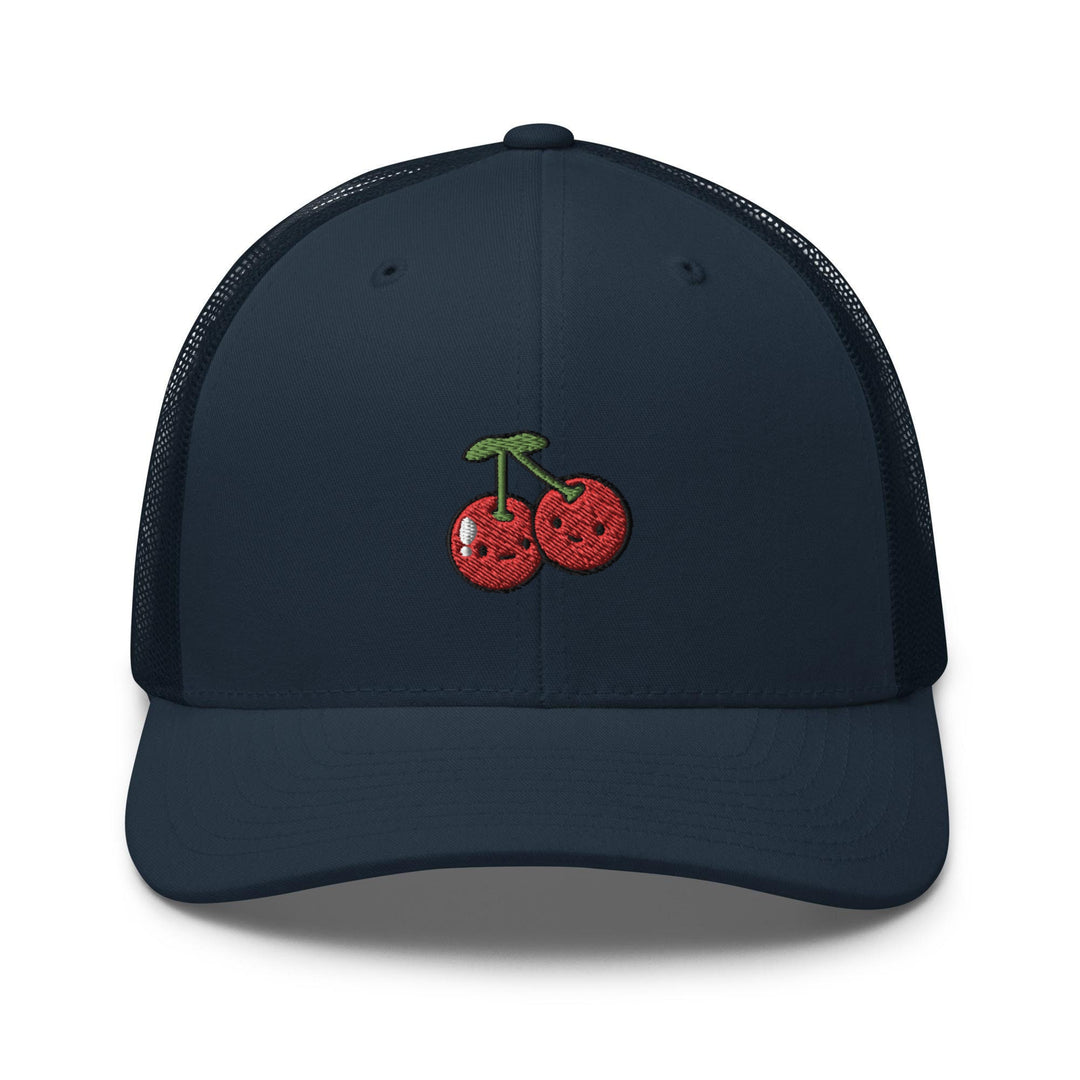 a blue hat with a cherry embroidered on it