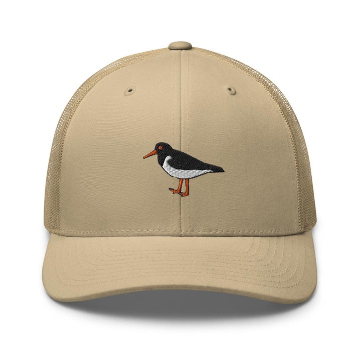 a tan hat with a black and white bird on it