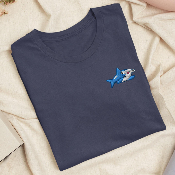 a blue t - shirt with a shark embroidered on it