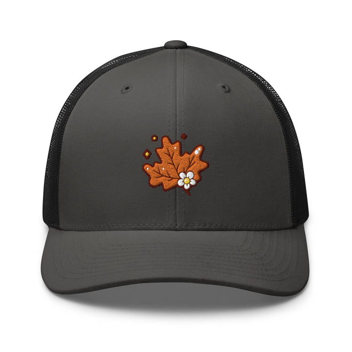 a gray and black trucker hat with an orange maple leaf embroidered on the front