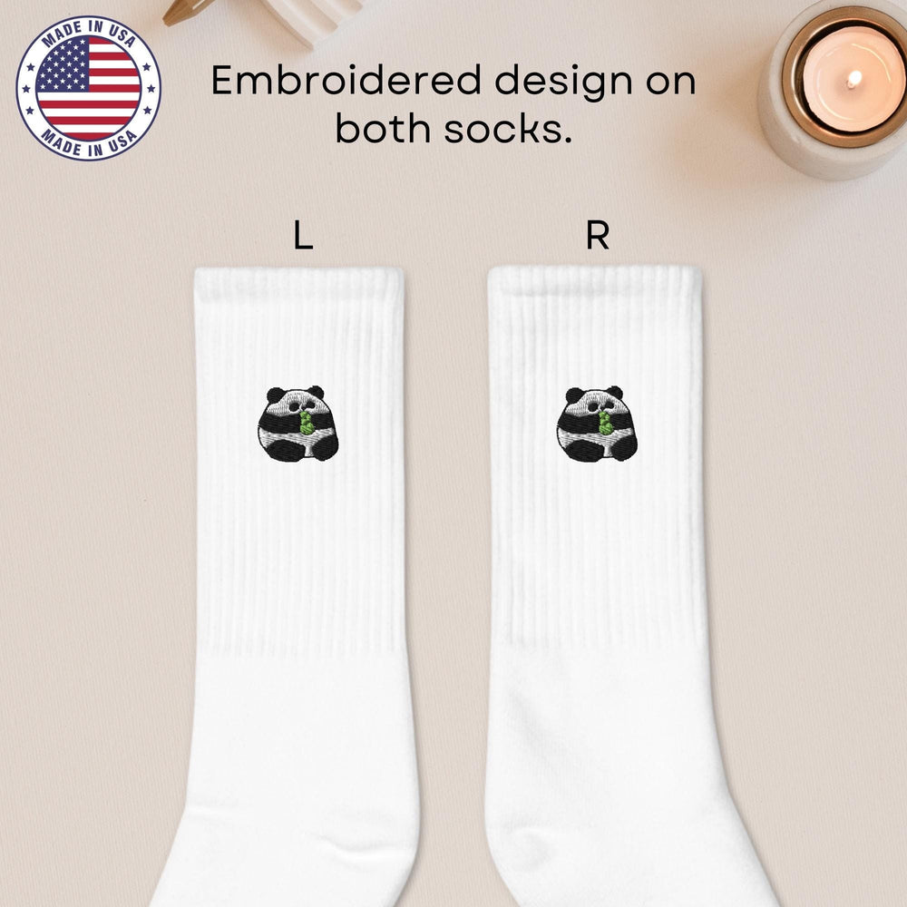 a pair of white socks with a panda bear on it