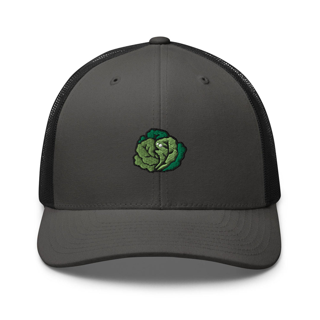 a gray and black trucker hat with a green flower on the front