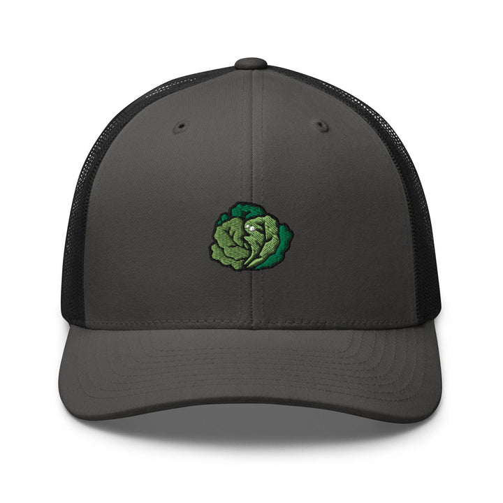 a gray and black trucker hat with a green flower on the front