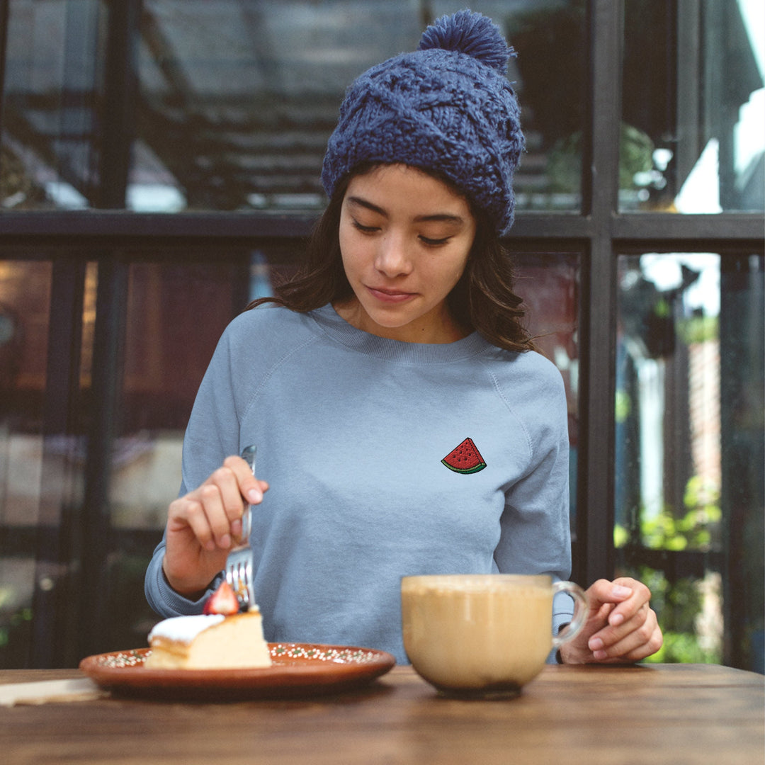 a woman sitting at a table eating cake