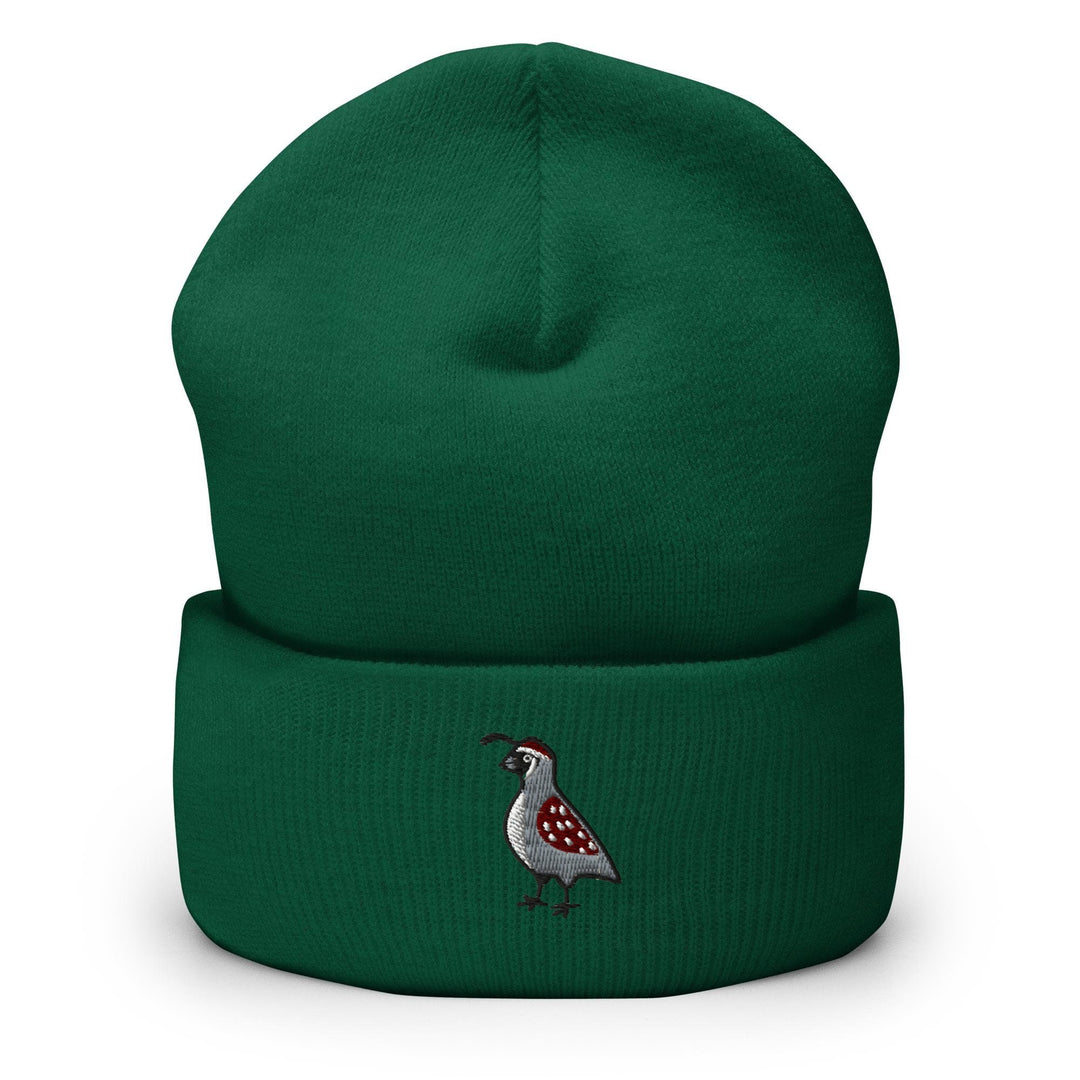 a green beanie with a bird embroidered on it