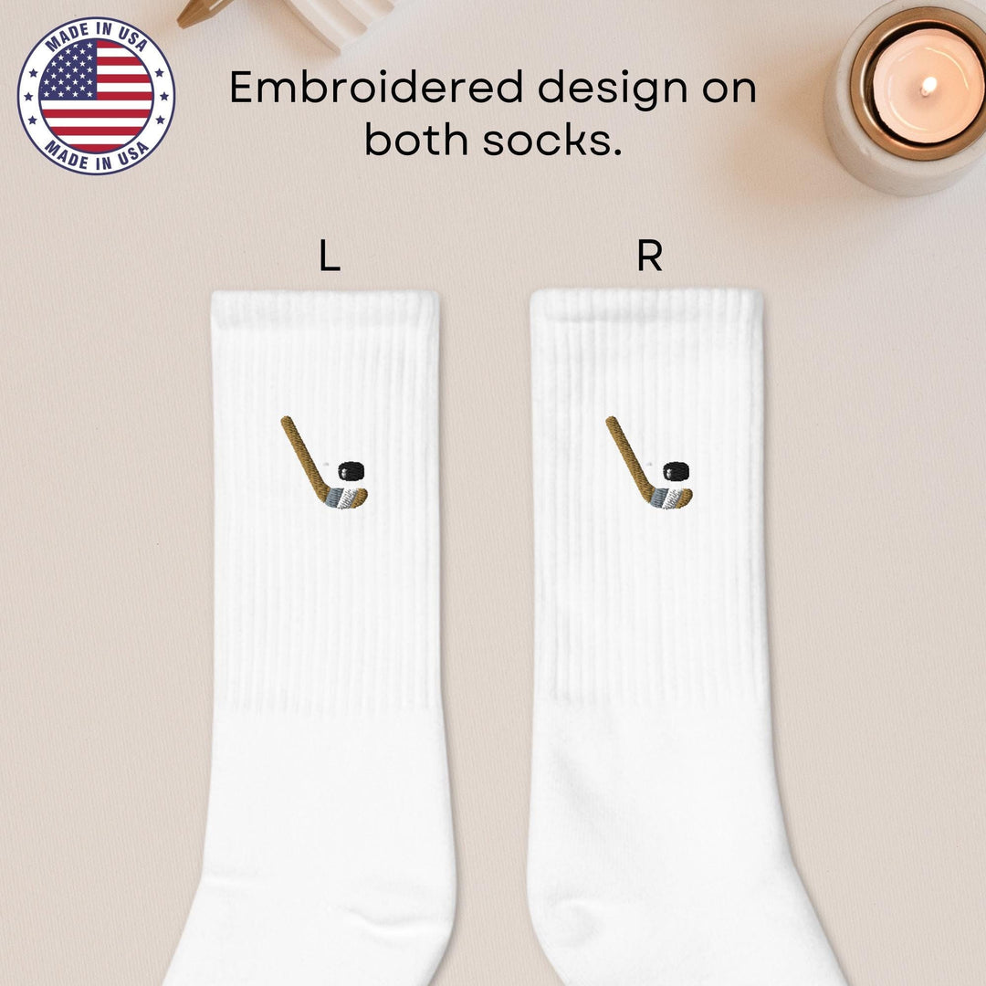 a pair of white socks with a hockey stick on them