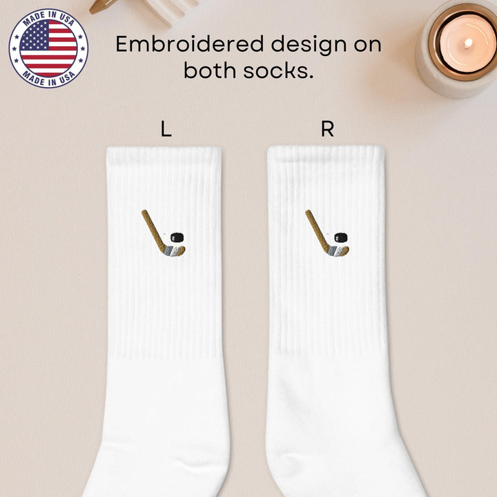 a pair of white socks with a hockey stick on them