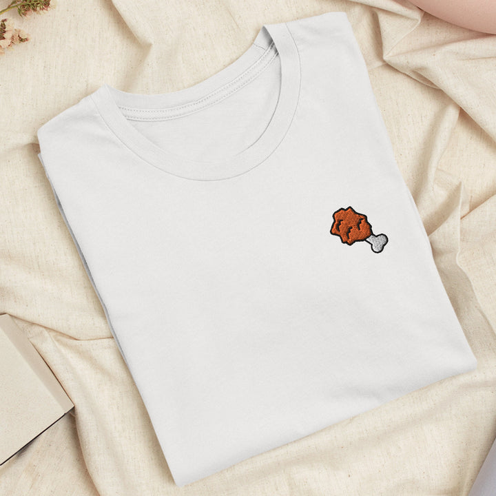 a white t - shirt with a red fish embroidered on it
