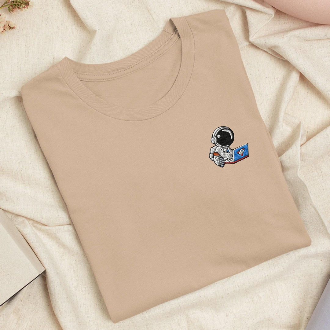 a t - shirt with an astronaut sticker on it
