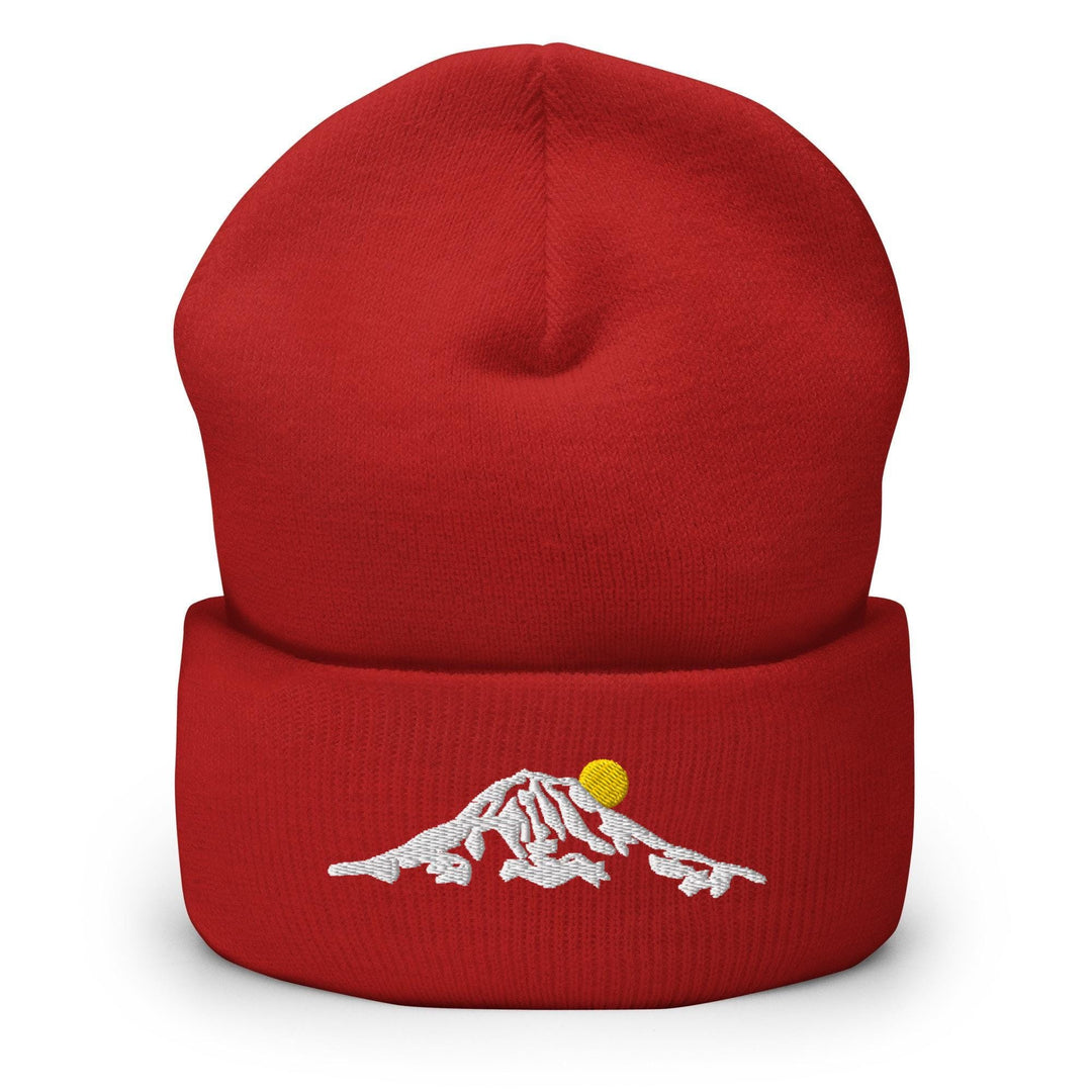 a red beanie hat with a mountain embroidered on it