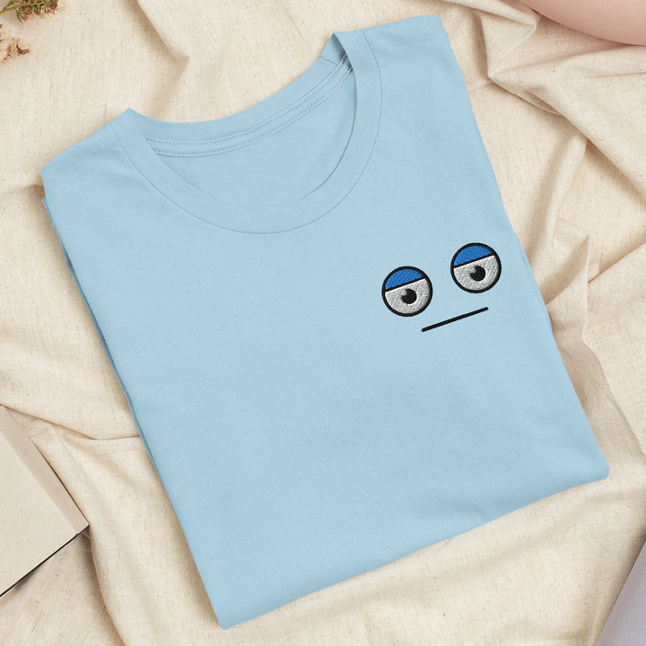 a blue t - shirt with a sad face drawn on it