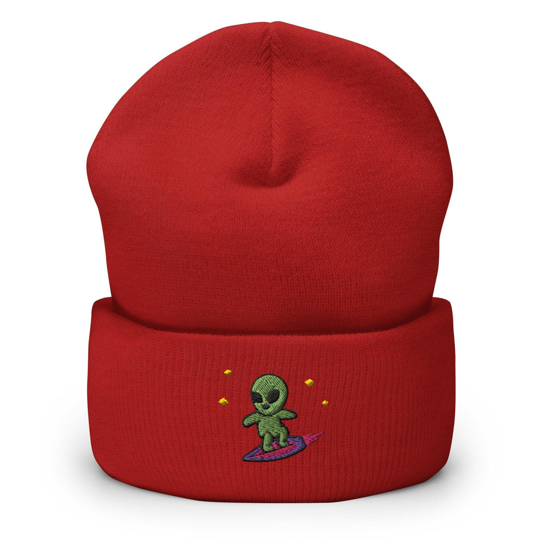 a red beanie with a green alien on it