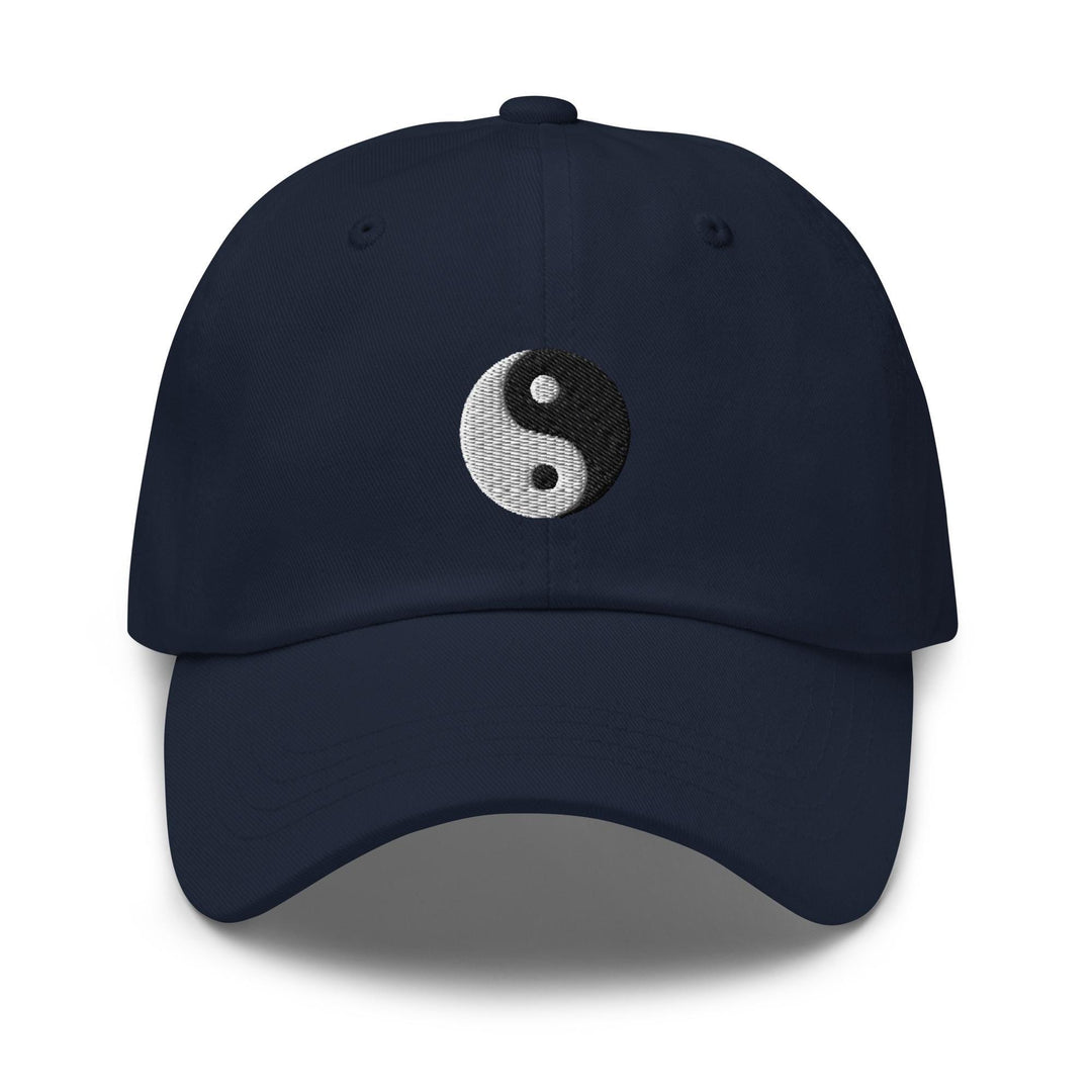a tan hat with a black and white yin yang symbol on it