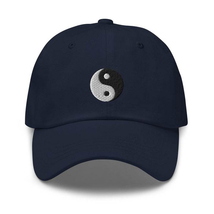 a tan hat with a black and white yin yang symbol on it