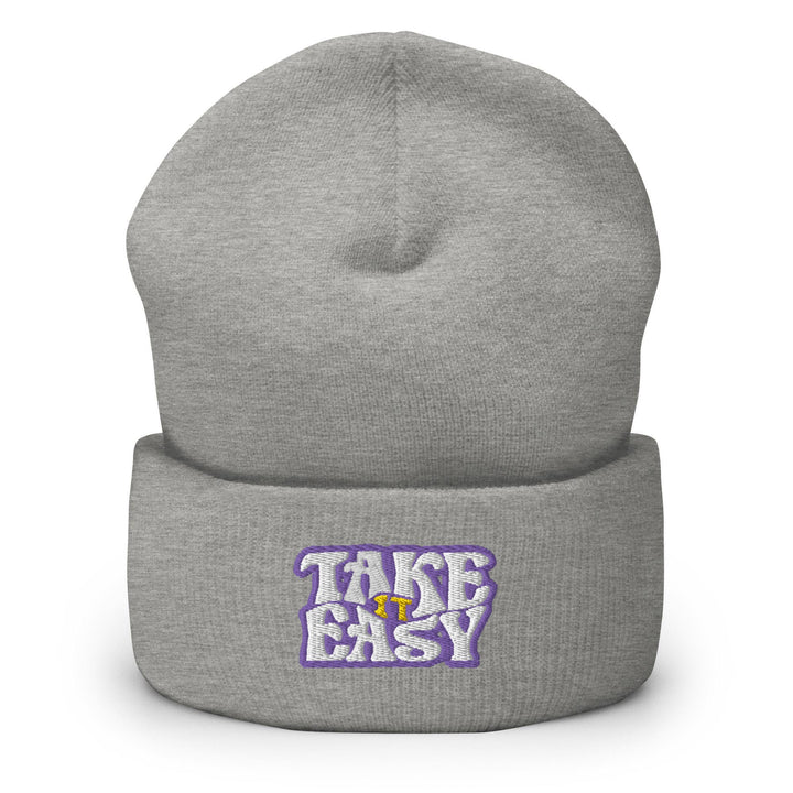 a grey beanie with the words take easy on it