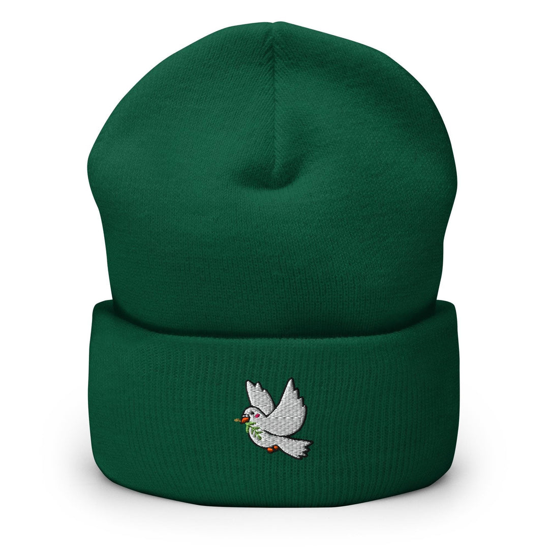 a green beanie with a white bird embroidered on it