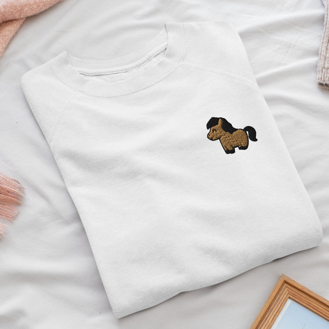 a white t - shirt with a brown dog embroidered on it