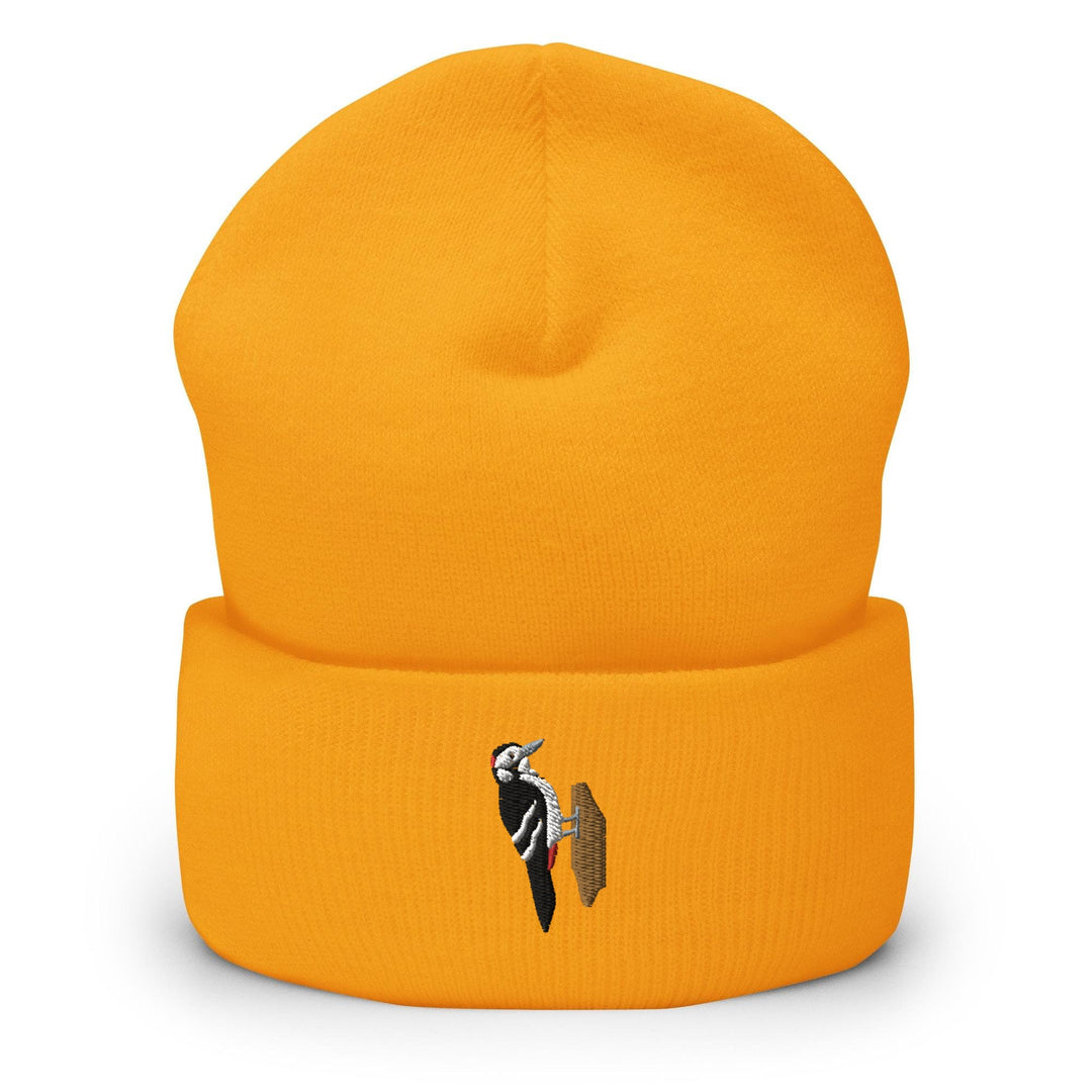 a yellow beanie with a black and white bird on it