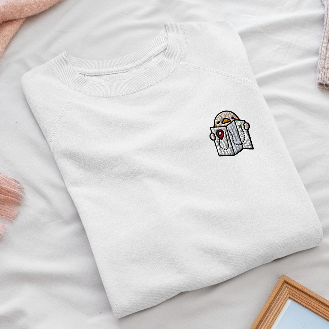 a white t - shirt with a picture of a bird on it