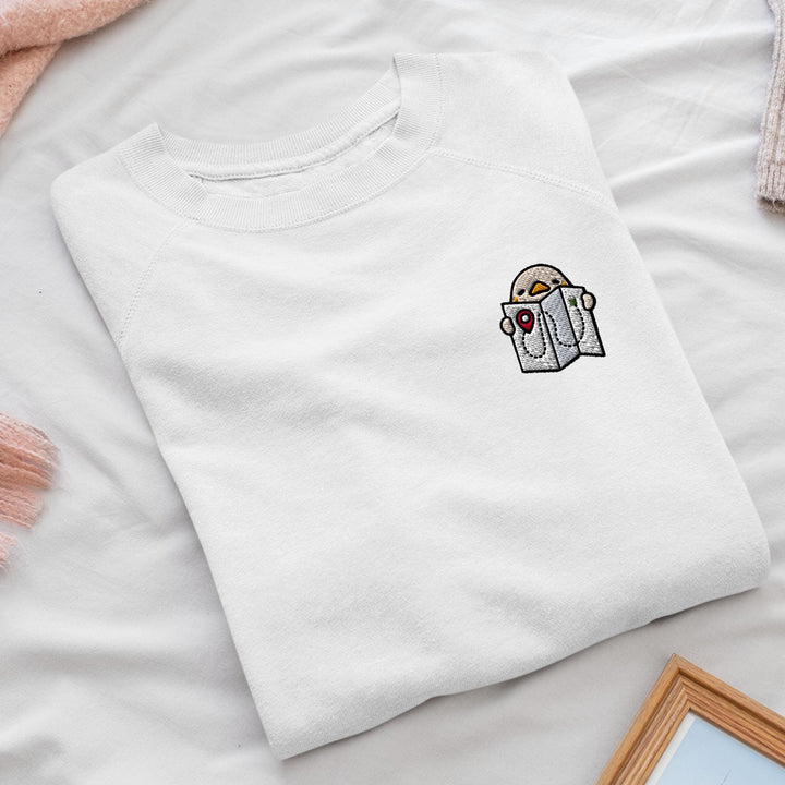 a white t - shirt with a picture of a bird on it