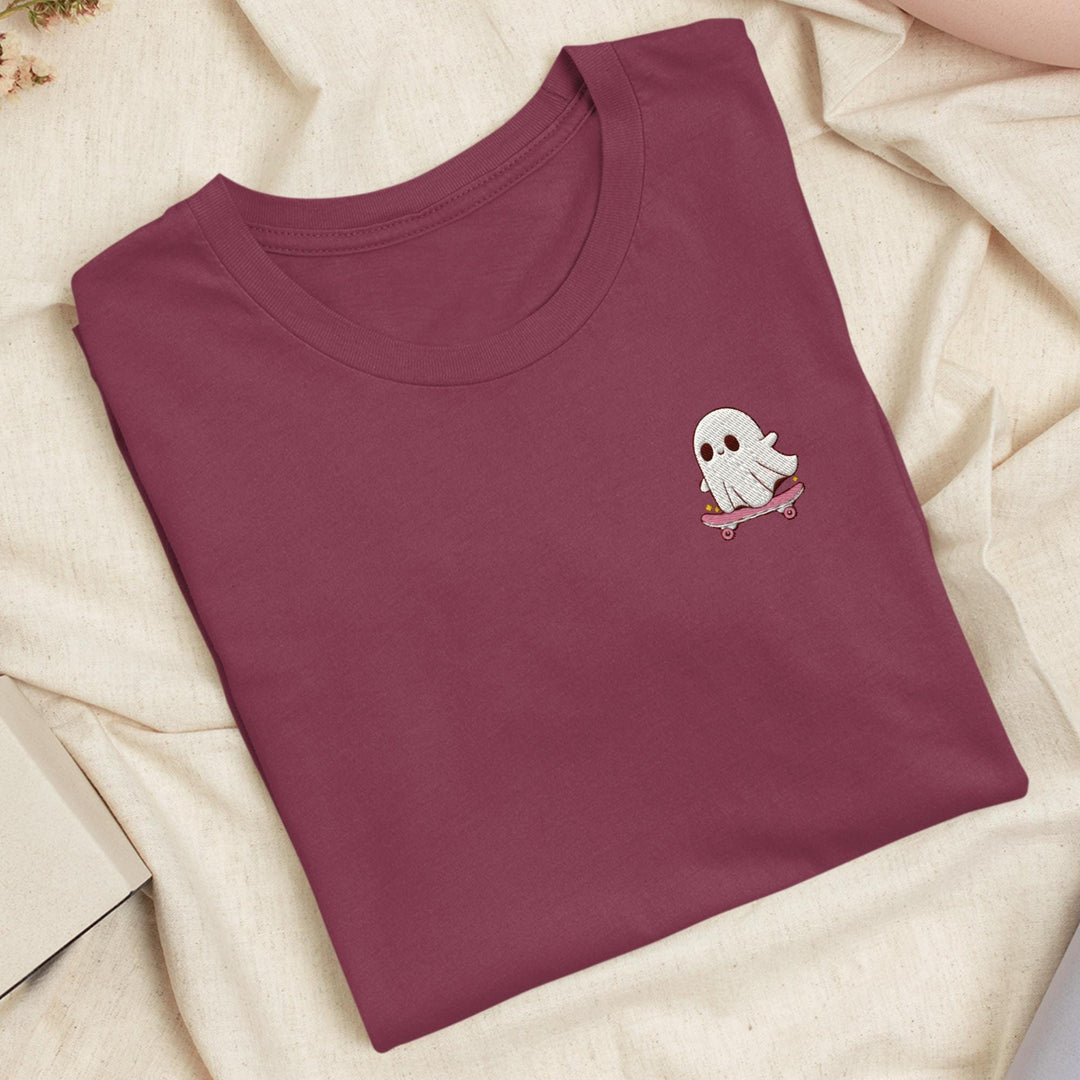 a red t - shirt with a white ghost on it