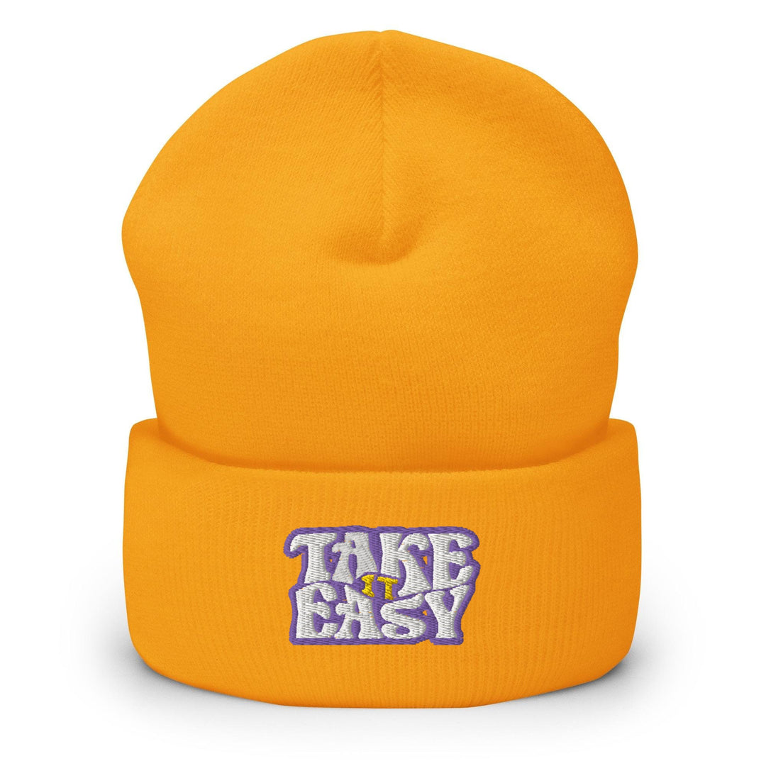 a yellow beanie with the words take easy on it