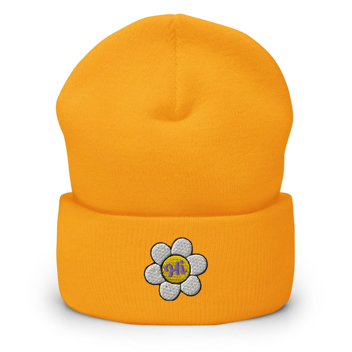 a yellow beanie with a flower on it