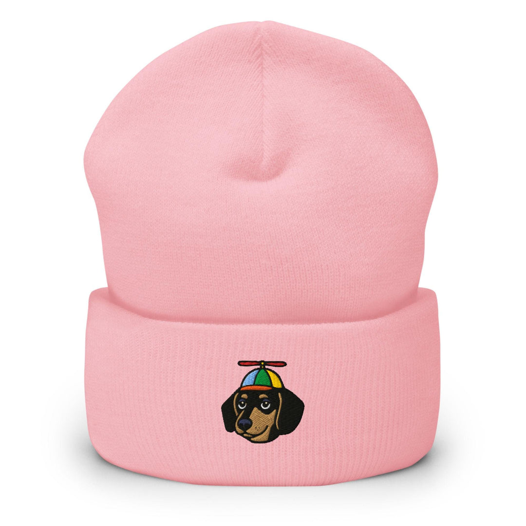 a pink beanie with a dog wearing a hat