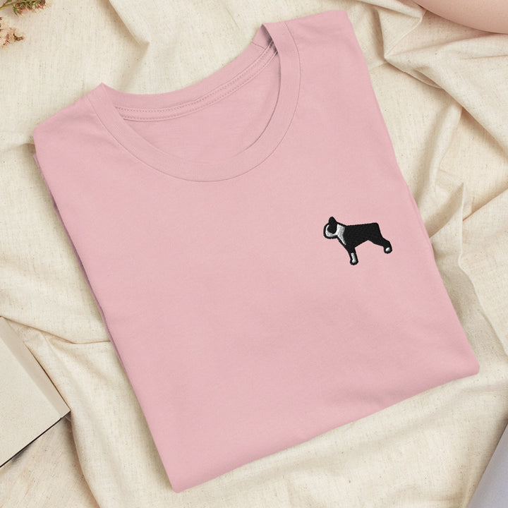 a pink shirt with a black dog on it