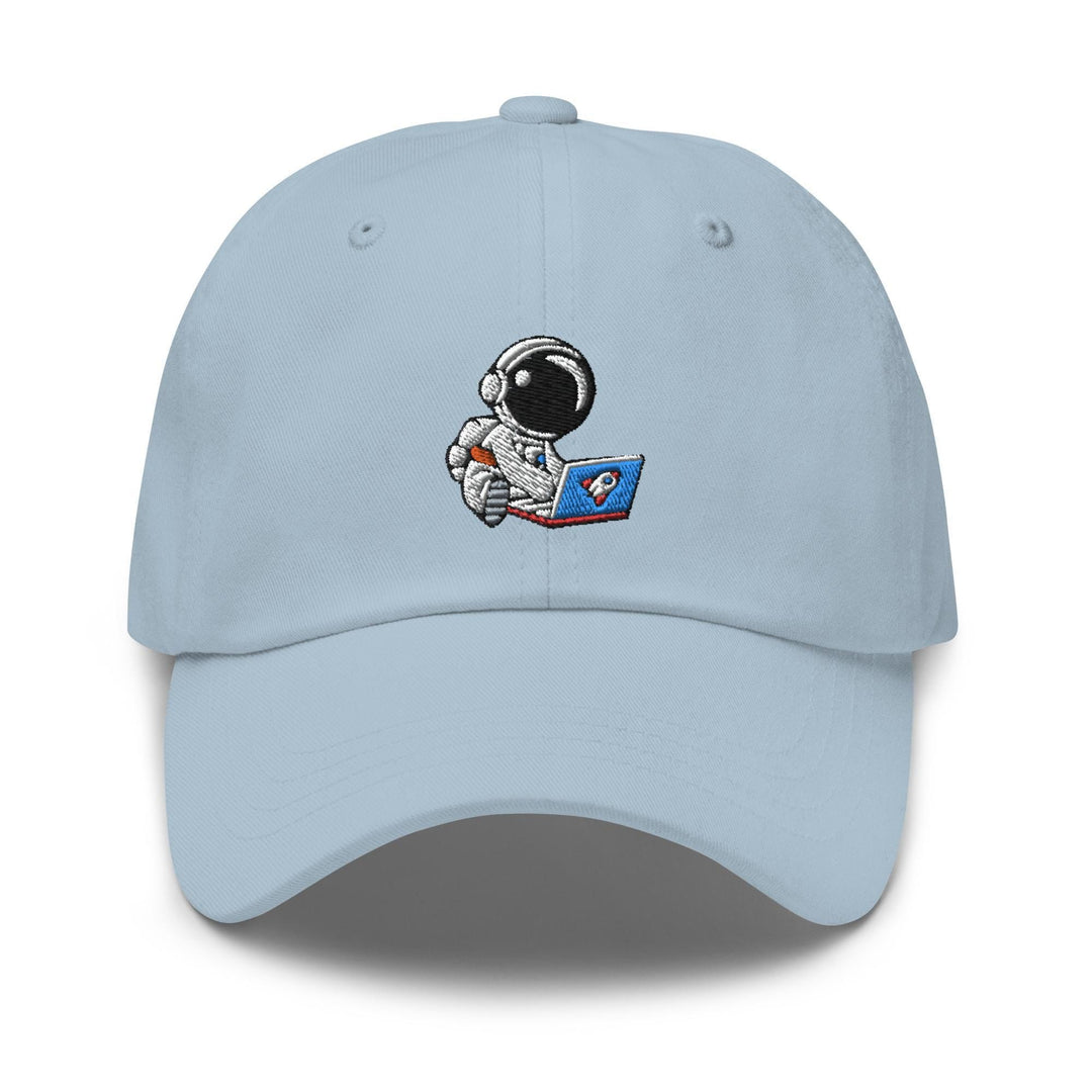 a light blue hat with an astronaut reading a book