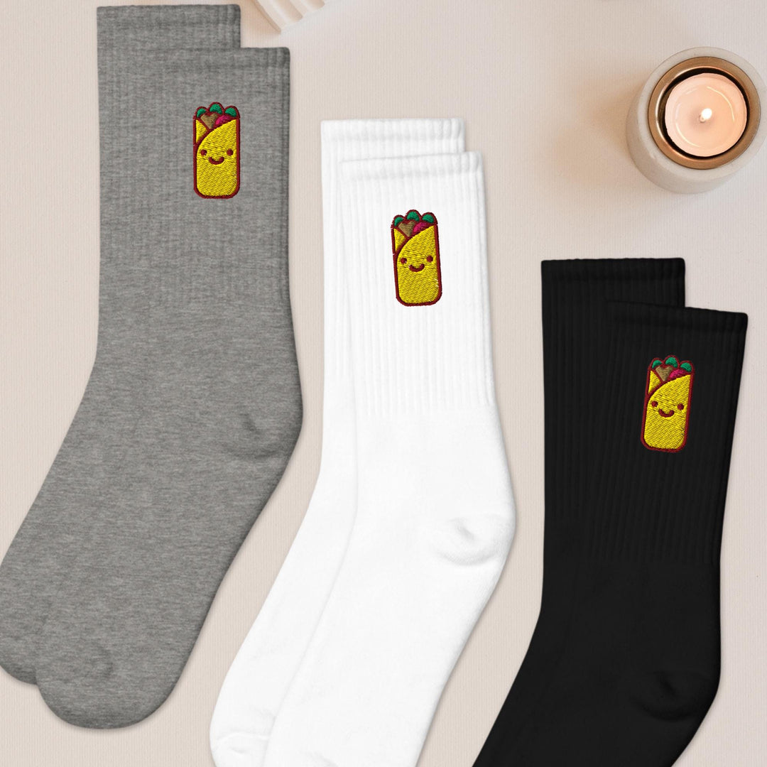 three pairs of socks sitting on top of a table