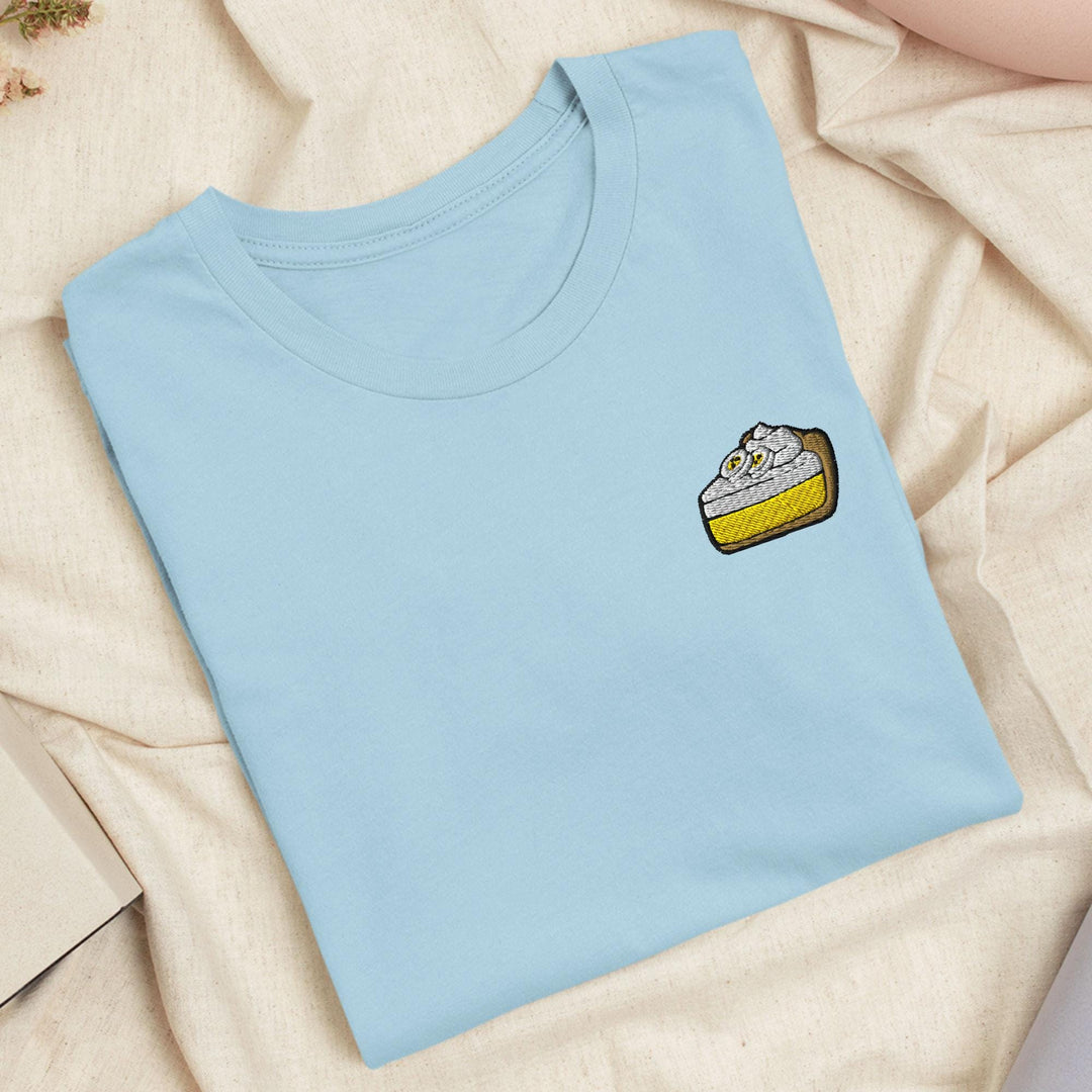 a blue t - shirt with a piece of cake on it