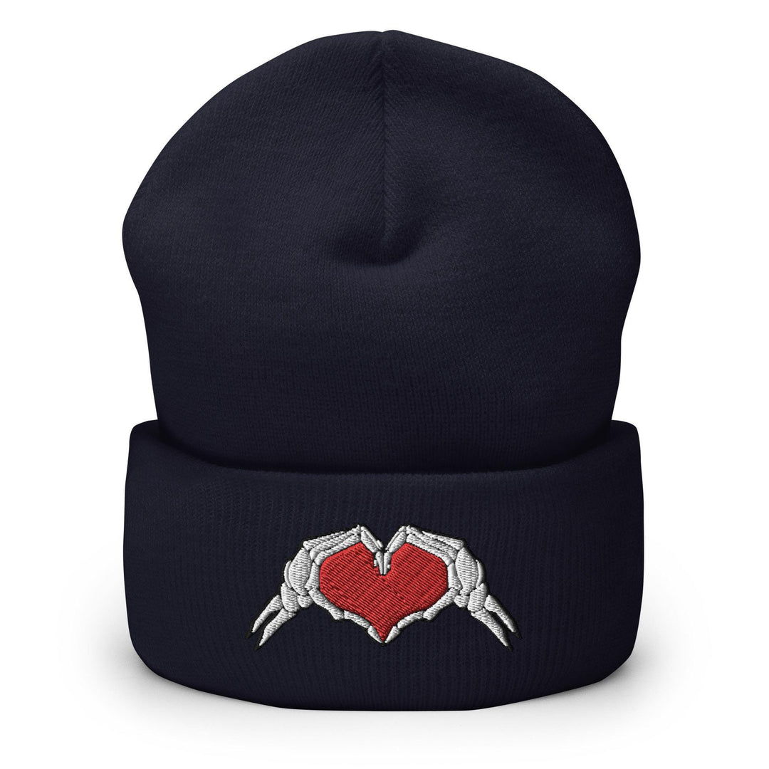 a beanie hat with two hands holding a heart