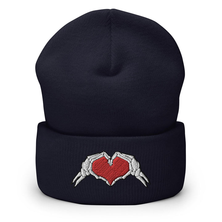 a beanie hat with two hands holding a heart