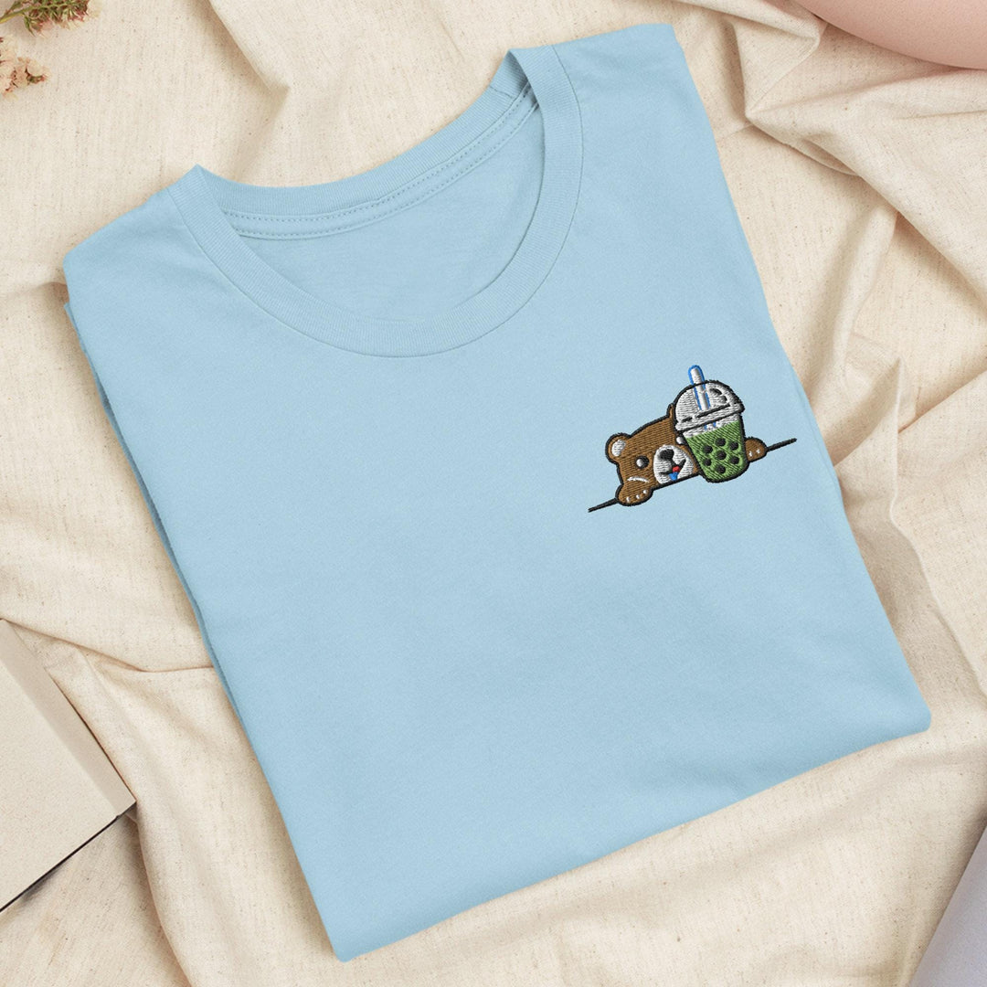 a blue t - shirt with a picture of a teddy bear on it