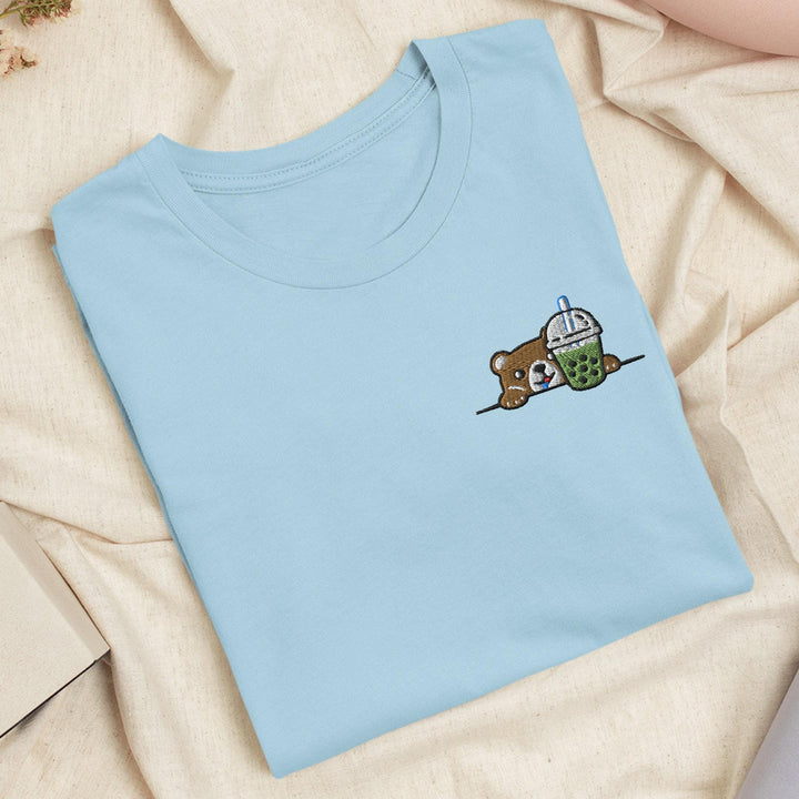 a blue t - shirt with a picture of a teddy bear on it